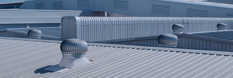Industrial metal rooftops with ventilation turbines.
