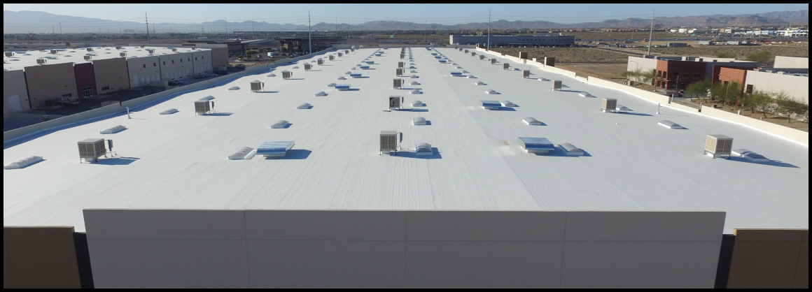 Expansive white commercial roof with HVAC units in industrial area.